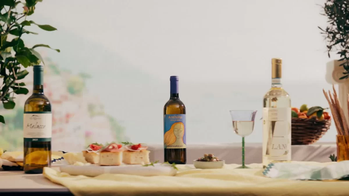 Weinflaschen und Speisen auf einer hellen Tafel für Manor Wine